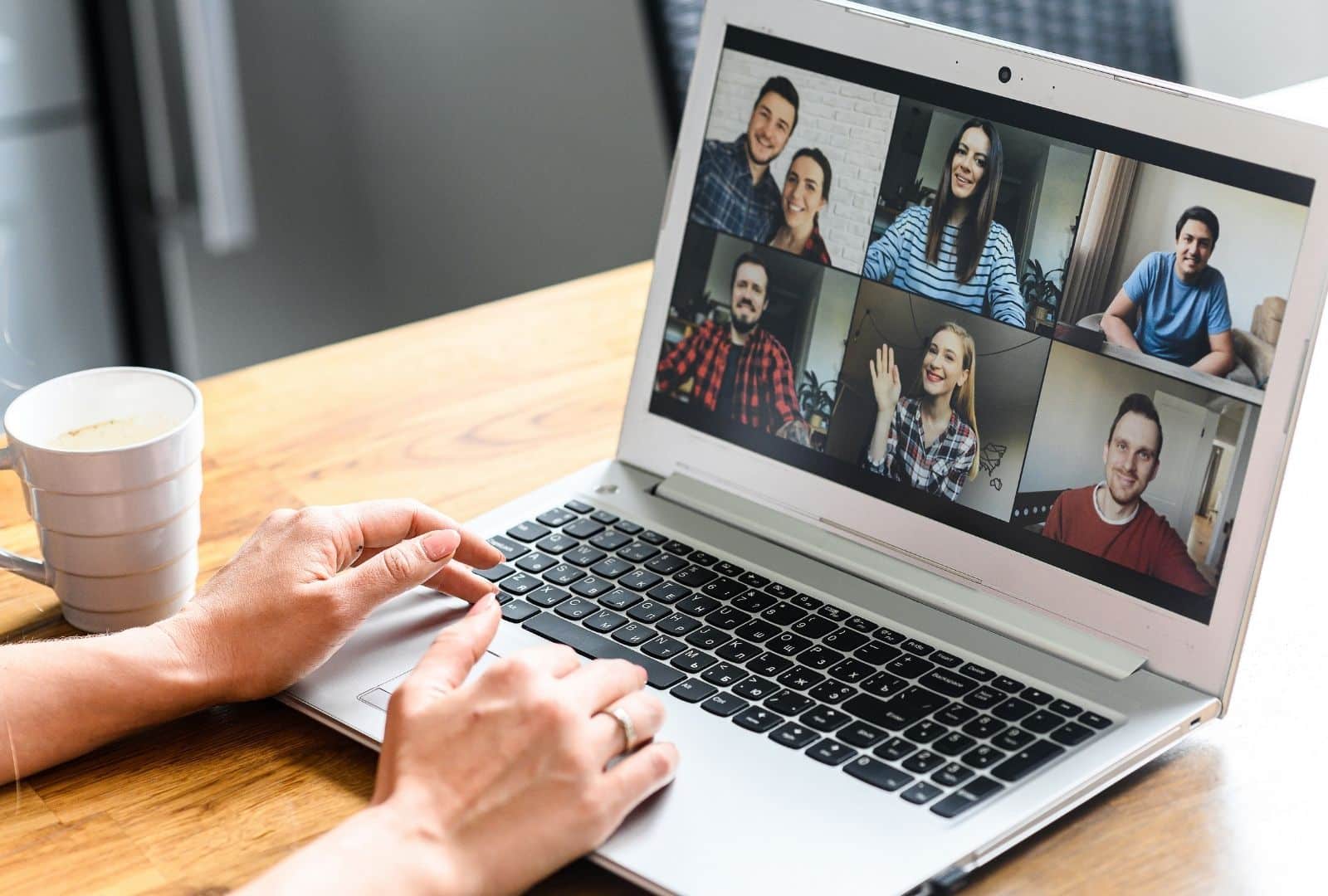 Anat Migdalor teaching Hebrew Zoom Lessons in a split-screen video call with five students on a laptop and tablet, emphasizing personalized online tutoring and interaction.